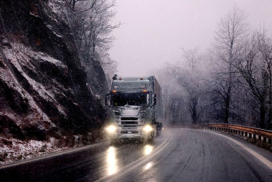Truck driving on a snowy winter road